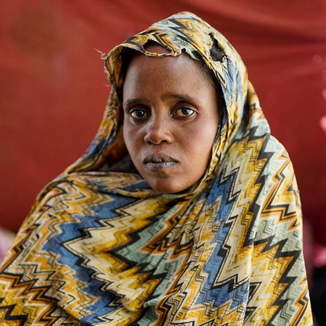 Israa Mukhtar, a witness of the RSF attack in April 2025 on Relief International's medical clinic in Sudan's Zamzam camp, sits inside a tent, in Tawila, North Darfur, Sudan, June 13, 2025. REUTERS/Stringer