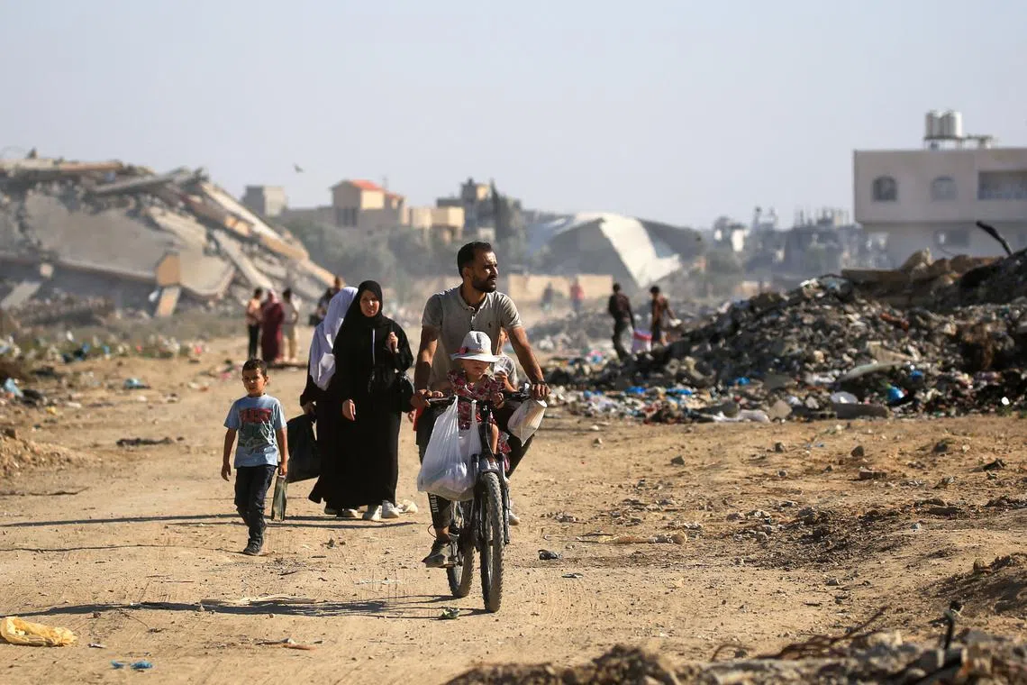 Palestinians use a path lined with destroyed buildings al-Bureij camp in the central Gaza Strip on June 2.