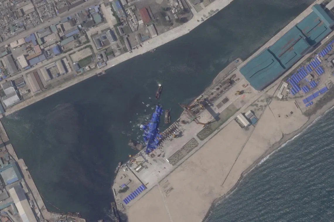 FILE PHOTO: A satellite image shows a North Korean warship covered with a blue tarp after an accident that occurred during its launch at the shipyard in Chongjin, North Korea, May 24, 2025. 2025 Planet Labs PBC/Handout via REUTERS/File Photo