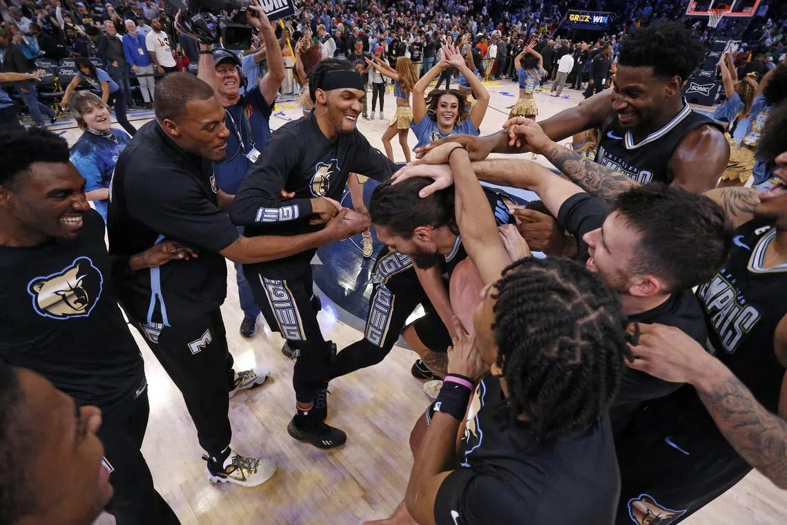 The Memphis Grizzlies celebrate with centre Steven Adams after defeating the Cleveland Cavaliers at FedExForum.