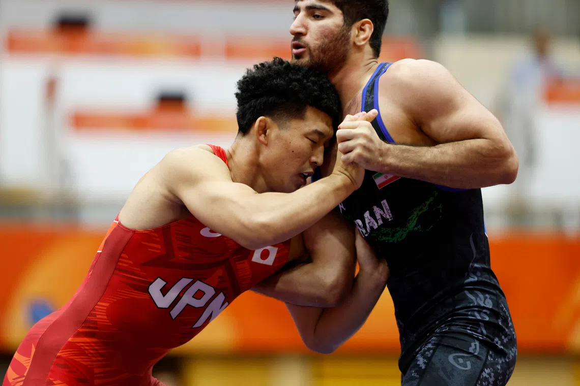 Asian Games - Aichi-Nagoya 2026 - Wrestling - Inae Sports Center, Nagoya, Japan - October 1, 2026 Iran's Alireza Abdevali in action during the men's greco-roman 77kg gold medal match against Japan's Nao Kusaka REUTERS/Eloisa Lopez