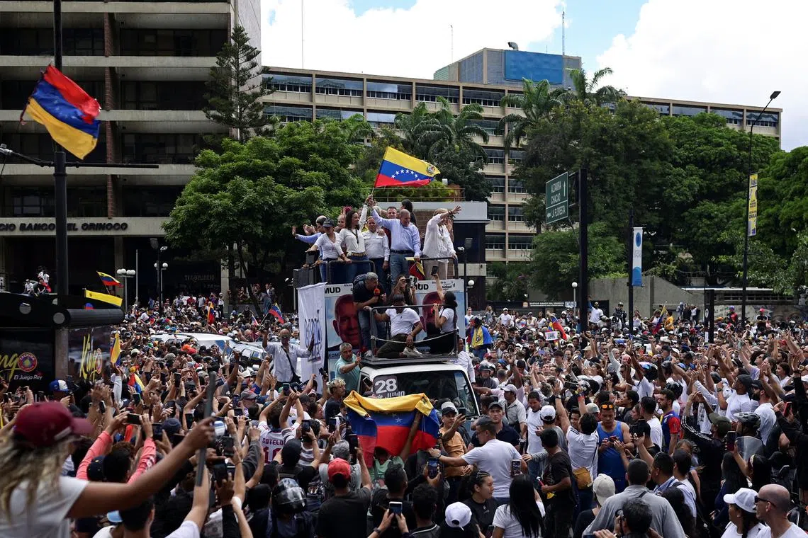 Opposition leader Maria Corina Machado and opposition candidate Edmundo Gonzalez wave as they address supporters after election results awarded Venezuela's President Nicolas Maduro with a third term, in Caracas, Venezuela July 30, 2024. REUTERS/Gaby Oraa