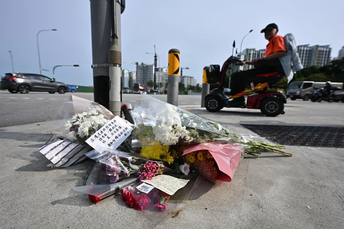 Bouquets of flowers placed below the traffic light near the accident site at Tampines Avenue 4 on April 23.