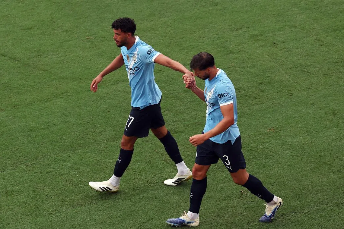 FILE PHOTO: Soccer Football - FIFA Club World Cup - Group G - Juventus v Manchester City - Camping World Stadium, Orlando, Florida, U.S. - June 26, 2025 Manchester City's Matheus Nunes and Manchester City's Ruben Dias celebrate their third goal scored by Manchester City's Erling Haaland REUTERS/Amanda Perobelli/File Photo