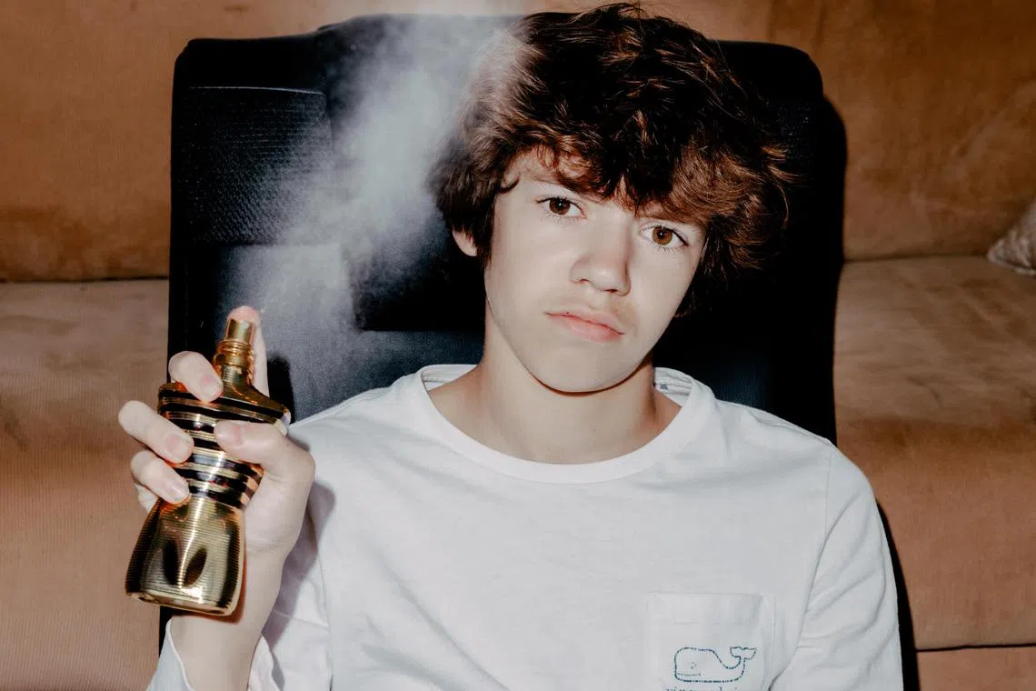 **EMBARGO: No electronic distribution, Web posting or street sales before 3:01 a.m. ET Sunday, May 19, 2024. No exceptions for any reasons. EMBARGO set by source.**  Logan Ayers, 13, spritzes his bottle of Jean Paul Gaultier cologne, in Chicago, Ill., April 28, 2024. Teenage boys have long turned to mists and sprays to drown out the first whiffs of puberty, but some even younger adolescents — whose parents have the cash, that is — are now becoming infatuated by designer colognes with price tags in the hundreds of dollars. (Evan Jenkins/The New York Times)