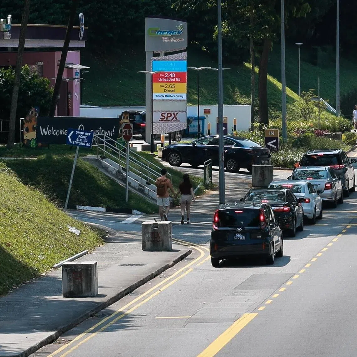 Vehicles queue for petrol at Cnergy station at Queensway at 11.13am on March 23, 2026.