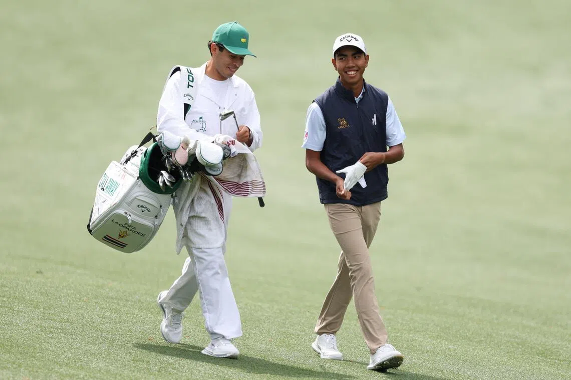 Thailand's Fifa Laopakdee and his caddie Santiago Botero walk the 13th hole at Augusta National Golf Club on April 6, during a practice round prior to the 2026 Masters Tournament.