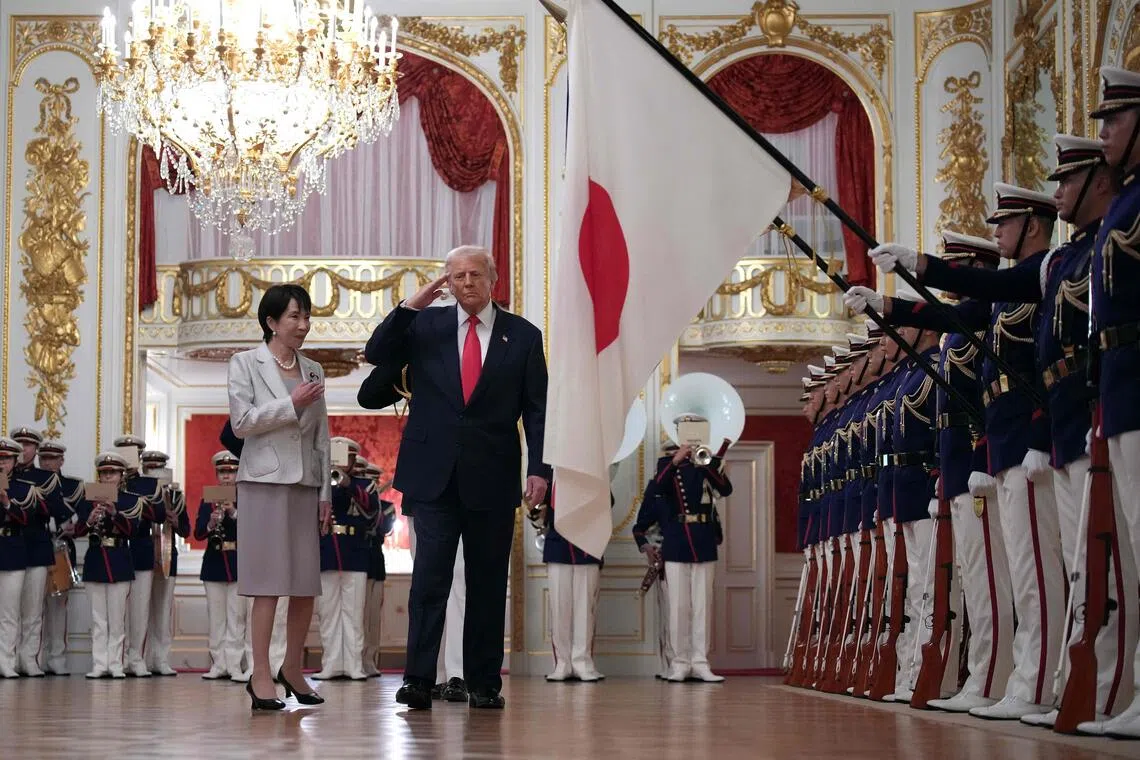 US President Donald Trump (right) views an honour guard with Japanese Prime Minister Sanae Takaichi (left) during a welcoming ceremony at Akasaka Palace on Oct 28, 2025 in Tokyo, Japan.  