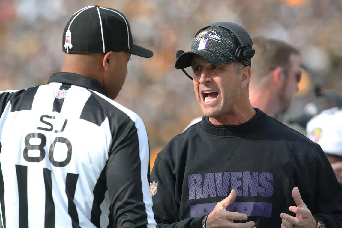 Nov 17, 2024; Pittsburgh, Pennsylvania, USA;  Baltimore Ravens head coach John Harbaugh (right) talks with side judge Alonzo Ramsey II (80) against the Pittsburgh Steelers during the first quarter at Acrisure Stadium. Mandatory Credit: Charles LeClaire-Imagn Images/ File Photo