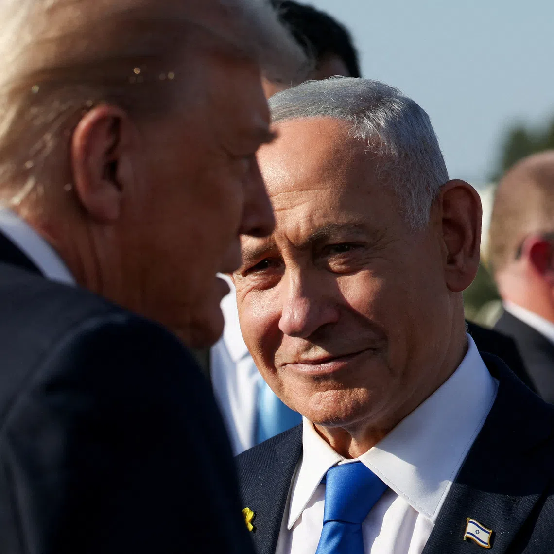 Israeli Prime Minister Benjamin Netanyahu looks on next to U.S. President Donald Trump as Trump leaves Israel en route to Sharm El-Sheikh, Egypt, to attend a world leaders' summit on ending the Gaza war, amid a U.S.-brokered prisoner-hostage swap and ceasefire deal between Israel and Hamas, at Ben Gurion International Airport in Lod, Israel, October 13, 2025. REUTERS/Evelyn Hockstein