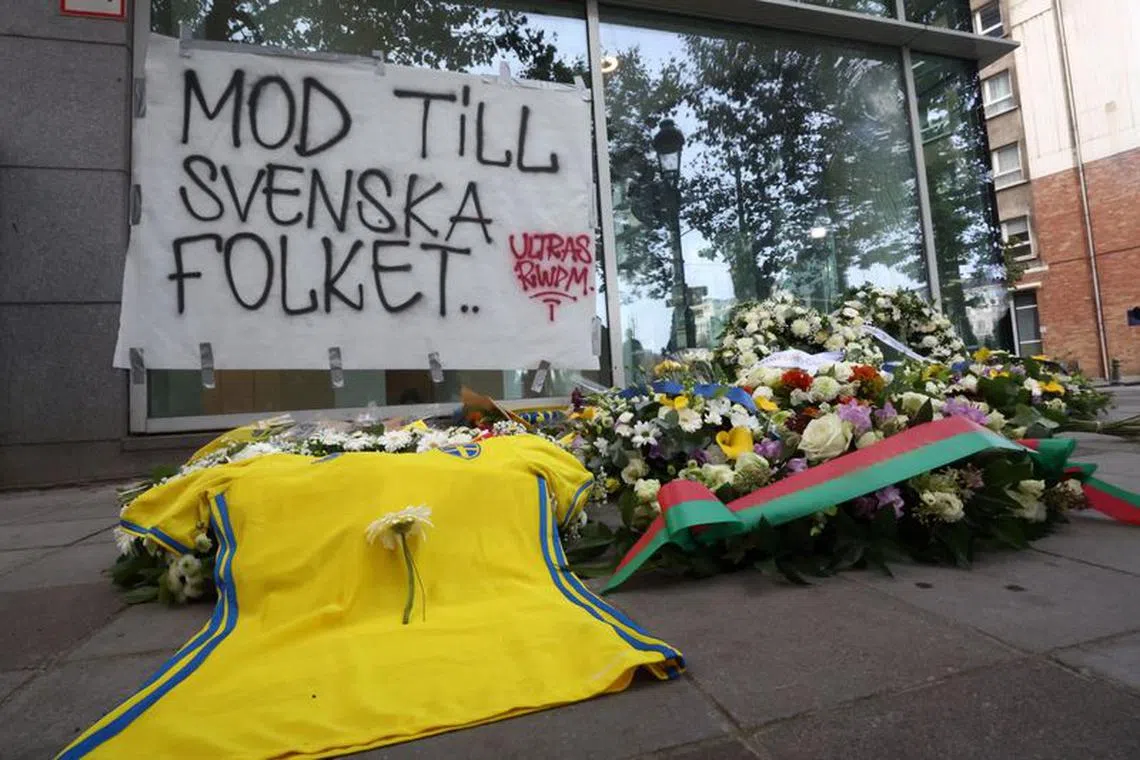 Flowers placed by Swedish Prime Minister Ulf Kristersson and Belgian Prime Minister Alexander De Croo are seen among other items left as a tribute to the victims two days after a gunman shot dead two Swedes, at the place of the shooting in Brussels, Belgium October 18, 2023. REUTERS/Yves Herman/File Photo