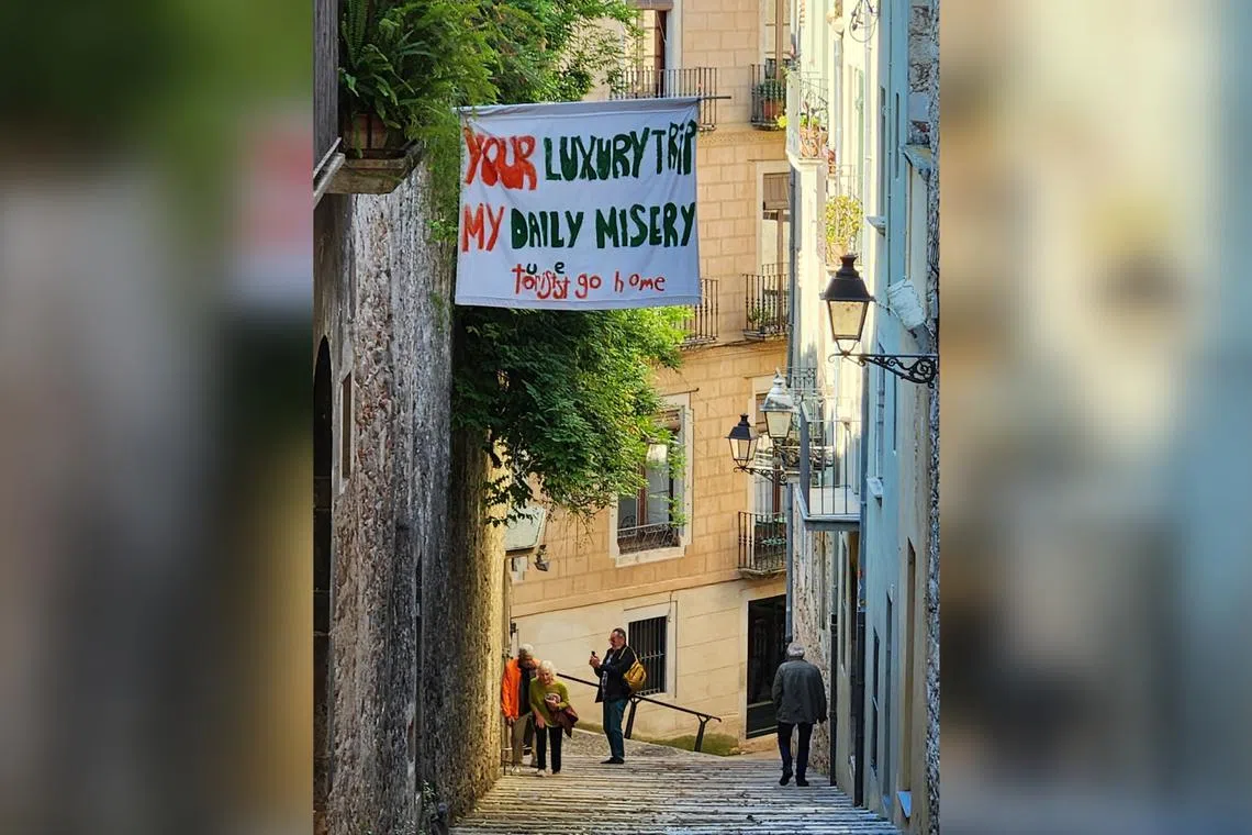 A resident in Girona, Spain put up a banner at his home asking tourists to go home. Photo taken on May 21, 2024.