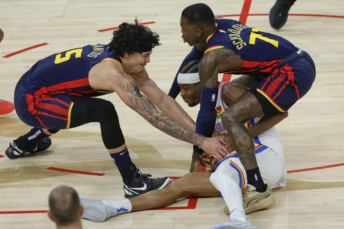 Oklahoma City Thunder guard Shai Gilgeous-Alexander (centre), Golden State Warriors guard Dennis Schroder (right) and Gui Santos competing for the ball during the first half of the Warriors' 116-109 National Basketball Association win over the Thunder at Chase Centre on Jan 29.