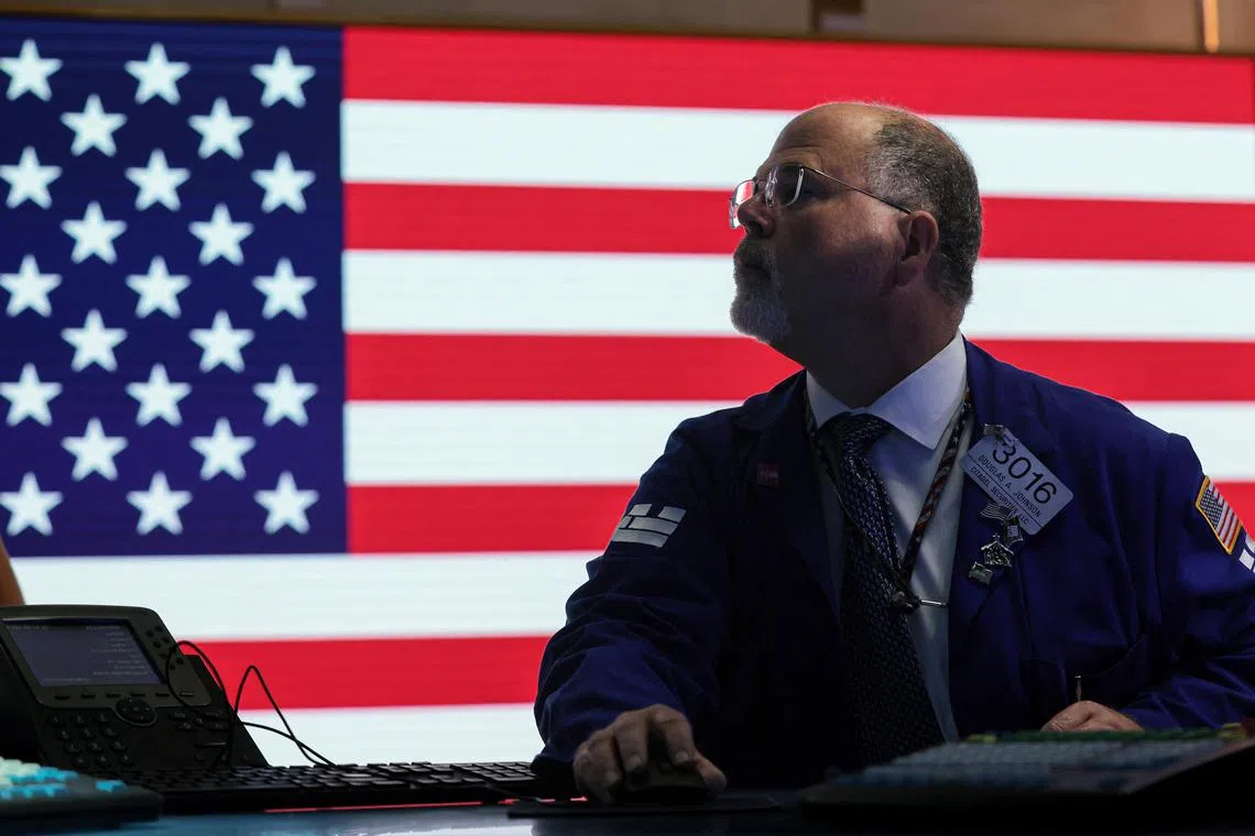 Traders work on the floor of the New York Stock Exchange, in New York City.