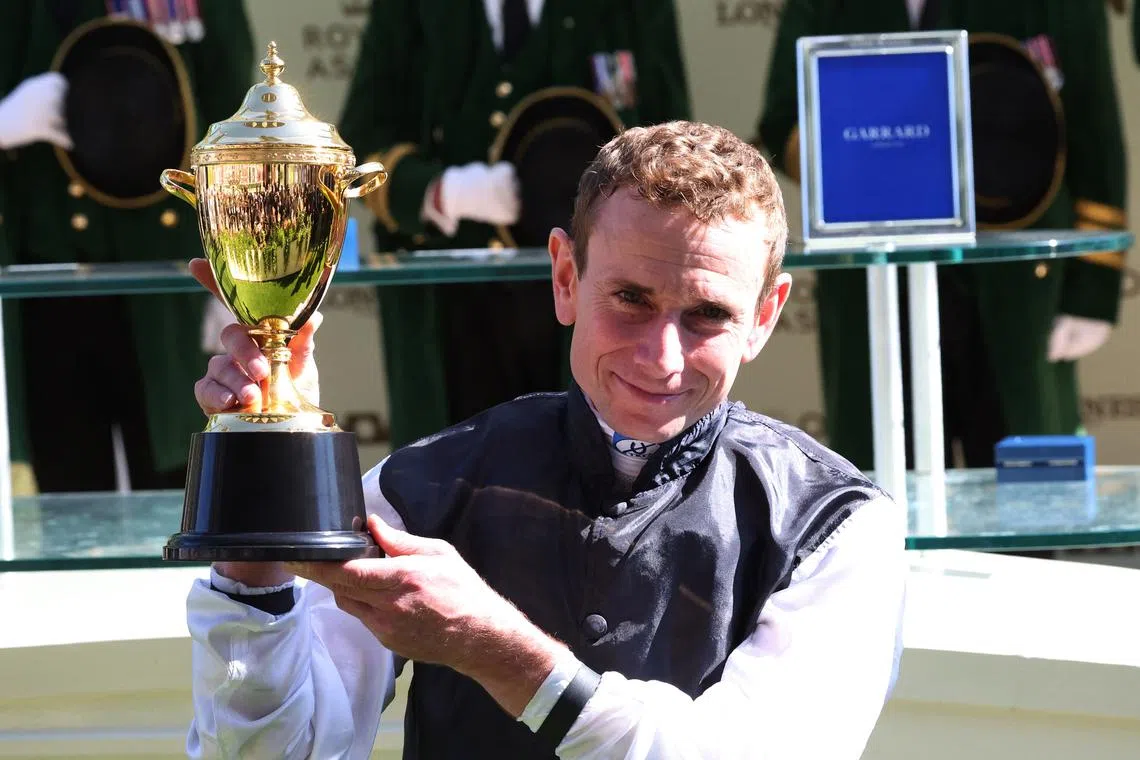 Horse Racing - Royal Ascot 2024 - Ascot Racecourse, Ascot, Britain - June 20, 2024 Ryan Moore celebrates with the trophy after winning the 16:25 Gold Cup riding Kyprios Action Images via Reuters/Andrew Boyers