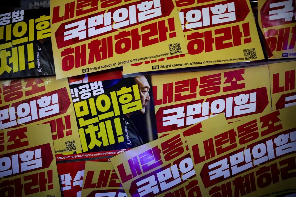 A placard with an image of South Korean President Yoon Suk Yeol is placed among other placards at a rally calling for the impeachment of South Korean President Yoon Suk Yeol, who declared martial law, which was reversed hours later, in front of the headquarters of the ruling People Power Party, in Seoul, South Korea, December 10, 2024. REUTERS/Kim Hong-Ji