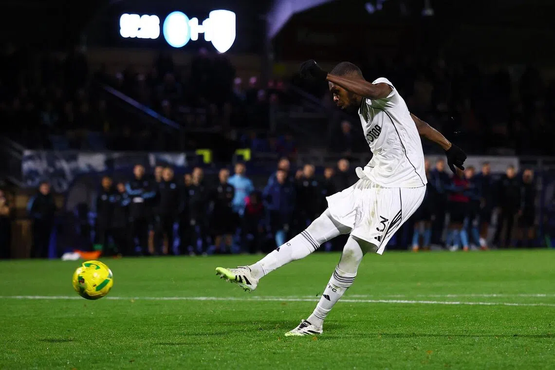 Fulham's Issa Diop scoring the winning penalty during the League Cup last-16 penalty shoot-out win over Wycombe Wanderers at Adams Park on Oct 28, 2025. The Cottagers prevailed 5-4 after the match ended 1-1.