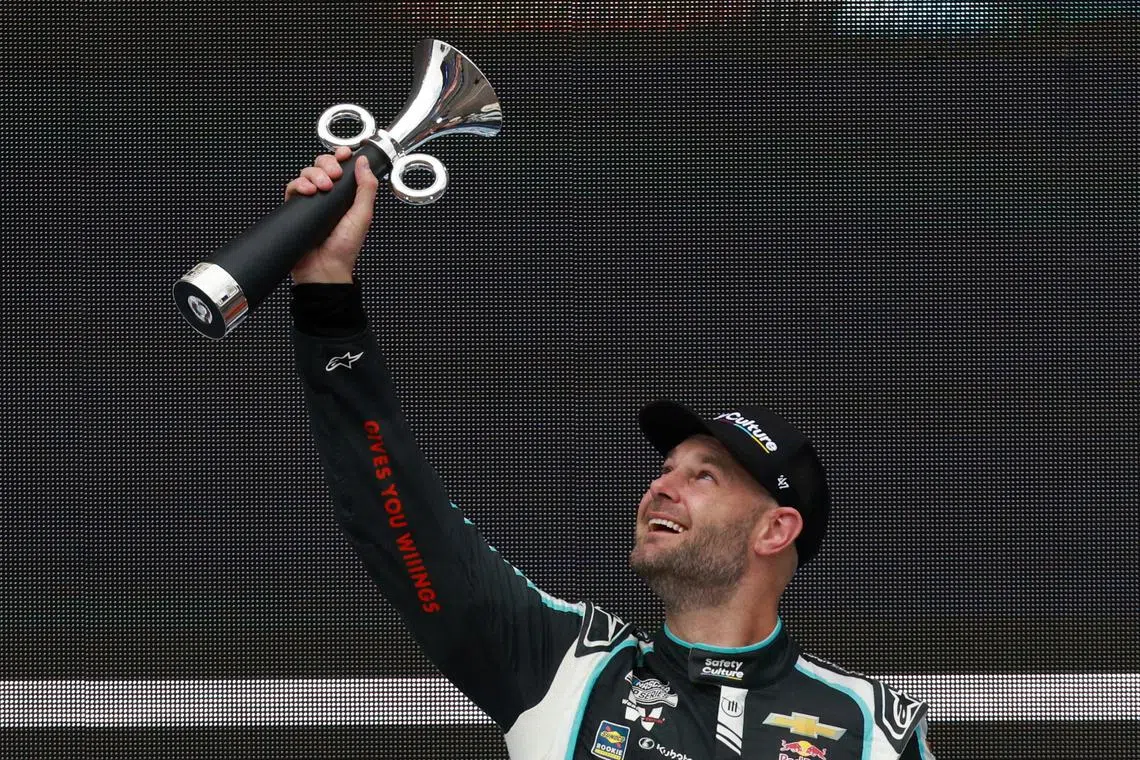 NASCAR - NASCAR Cup Series Mexico - Autodromo Hermanos Rodriguez, Mexico City, Mexico - June 15, 2025 Trackhouse Racing's Shane Van Gisbergen celebrates with a trophy on the podium after winning the NASCAR Cup Series Mexico REUTERS/Henry Romero