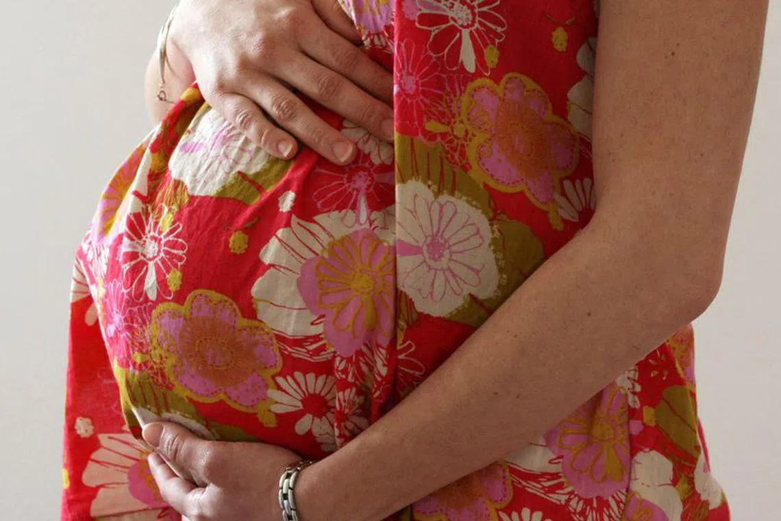 FILE PHOTO: A woman holds her stomach at the last stages of her pregnancy in Bordeaux April 28, 2010. REUTERS/Regis Duvignau/File Photo