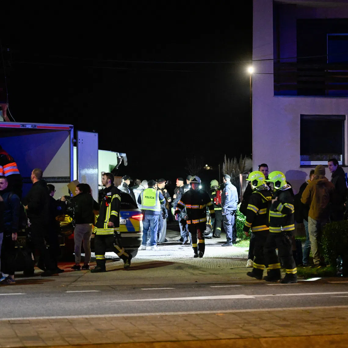 First responders attend the scene of a collision between two trains in the town of Pezinok, Slovakia.