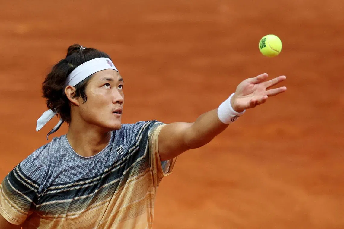 China's Zhang Zhizhen in action during his round of 16 match against Taylor Fritz of the United States.