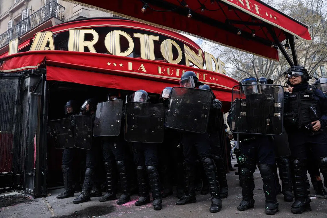 French riot police form a cordon around La Rotonde during clashes with protesters on April 6.