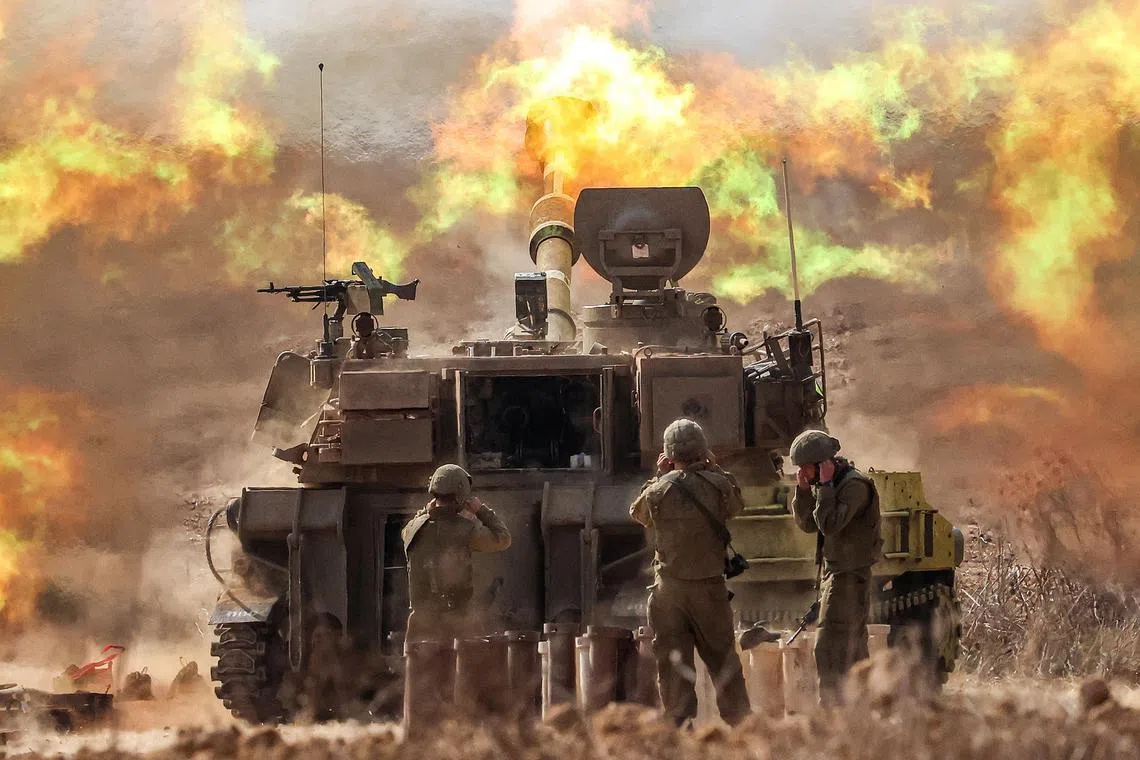 An Israeli army self-propelled howitzer firing rounds near the border with Gaza in southern Israel on Oct 11. Israel declared war on Hamas on October 8 following a shock land, air, and sea assault by the Gaza-based militant group. 
