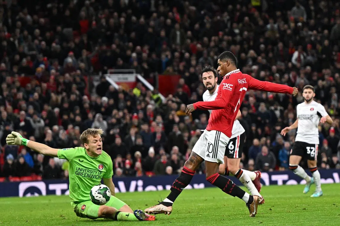 Manchester United's English striker Marcus Rashford scores their second goal.