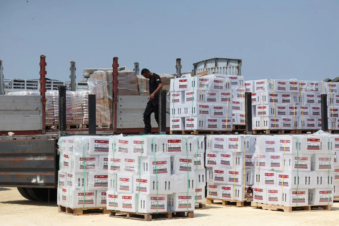FILE PHOTO: A worker unloads humanitarian aid, amid the ongoing conflict in Gaza between Israel and the Palestinian Islamist group Hamas, near the Erez Crossing point in northern Gaza, May 1, 2024. REUTERS/Ronen Zvulun/File Photo