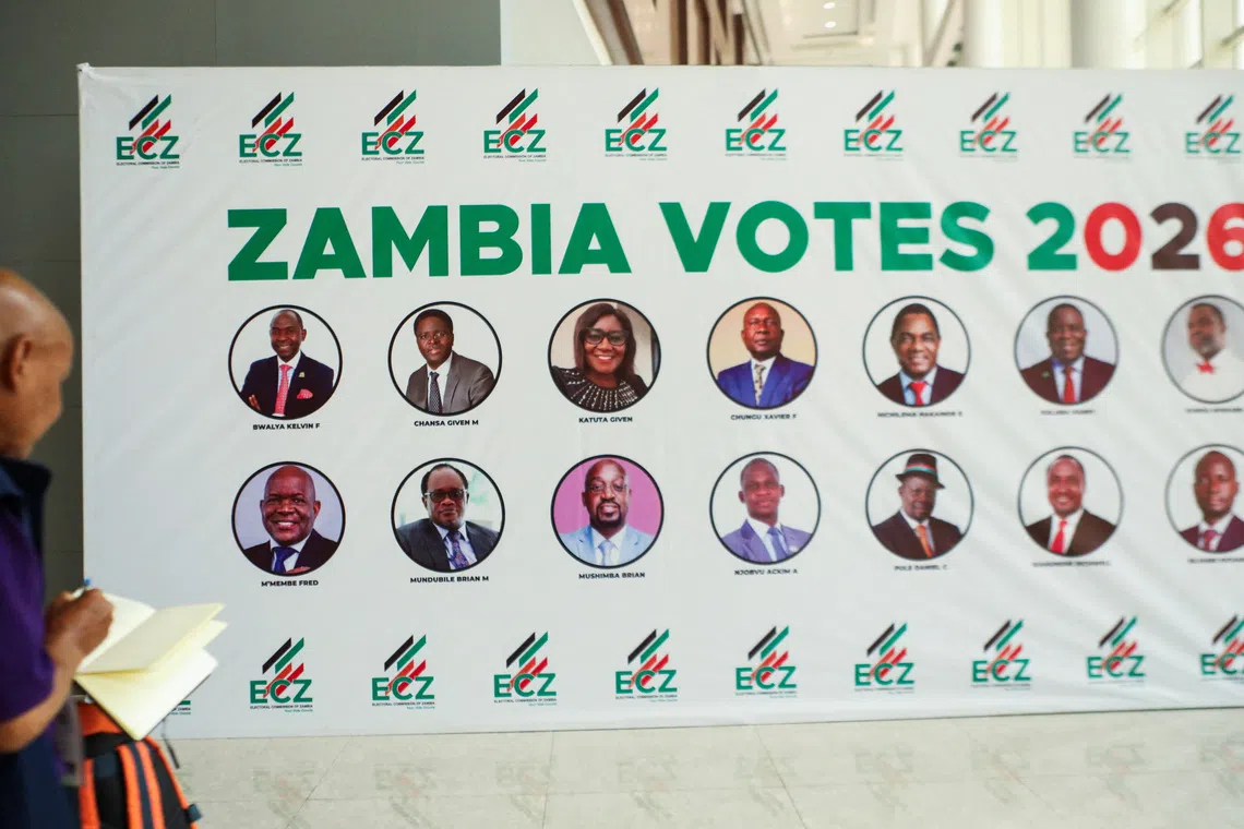 A person writes down names from a banner displaying candidates for Zambia's 2026 general election at the Mulungushi International Conference Centre ahead of the country's general election on August 13, in Lusaka, Zambia, August 12, 2026. REUTERS/Jean Mandela