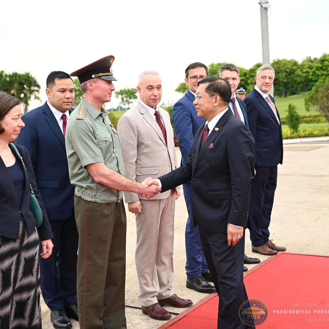 Myanmar President Min Aung Hlaing greeting a foreign military attache as he departs for Russia, at the Naypyitaw International Airport in Myanmar on Aug 17.