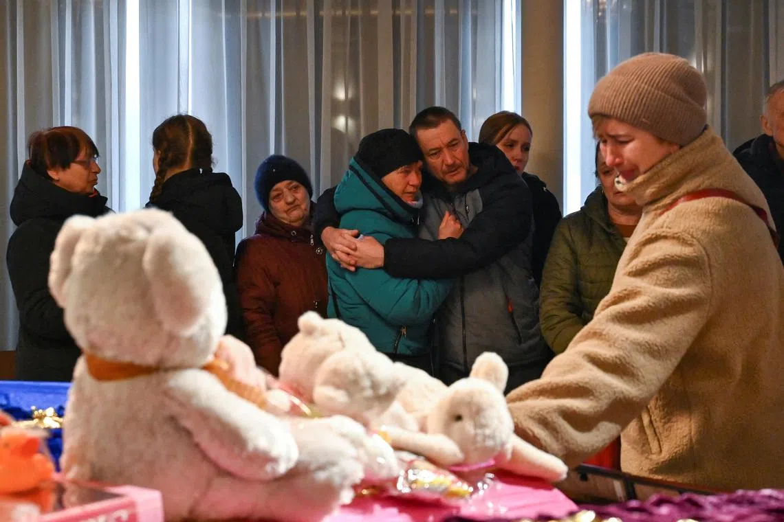 The funeral of a family killed by a Russian missile strike in Zaporizhzhia. 