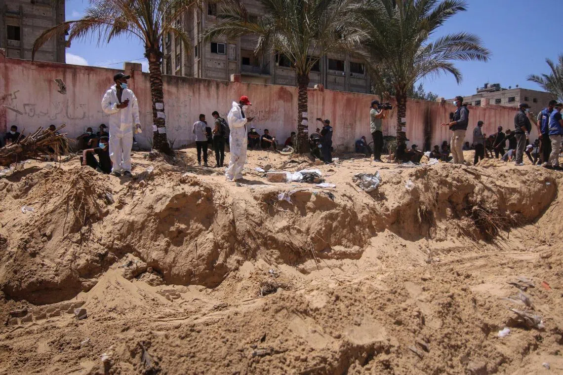 Palestinian health workers dig for bodies in a mass grave at the Nasser Medical Hospital compound in Khan Younis, southern Gaza, on April 21.