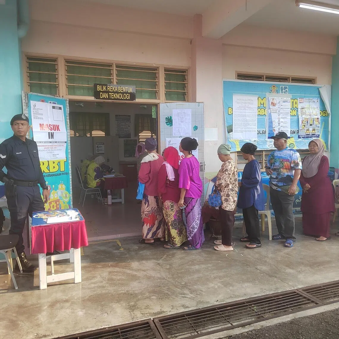 Voters waiting for their turn to cast votes at Sekolah Kebangsaan Putra Simpang Durian in Pertang, Negeri Sembilan, on Aug 1.