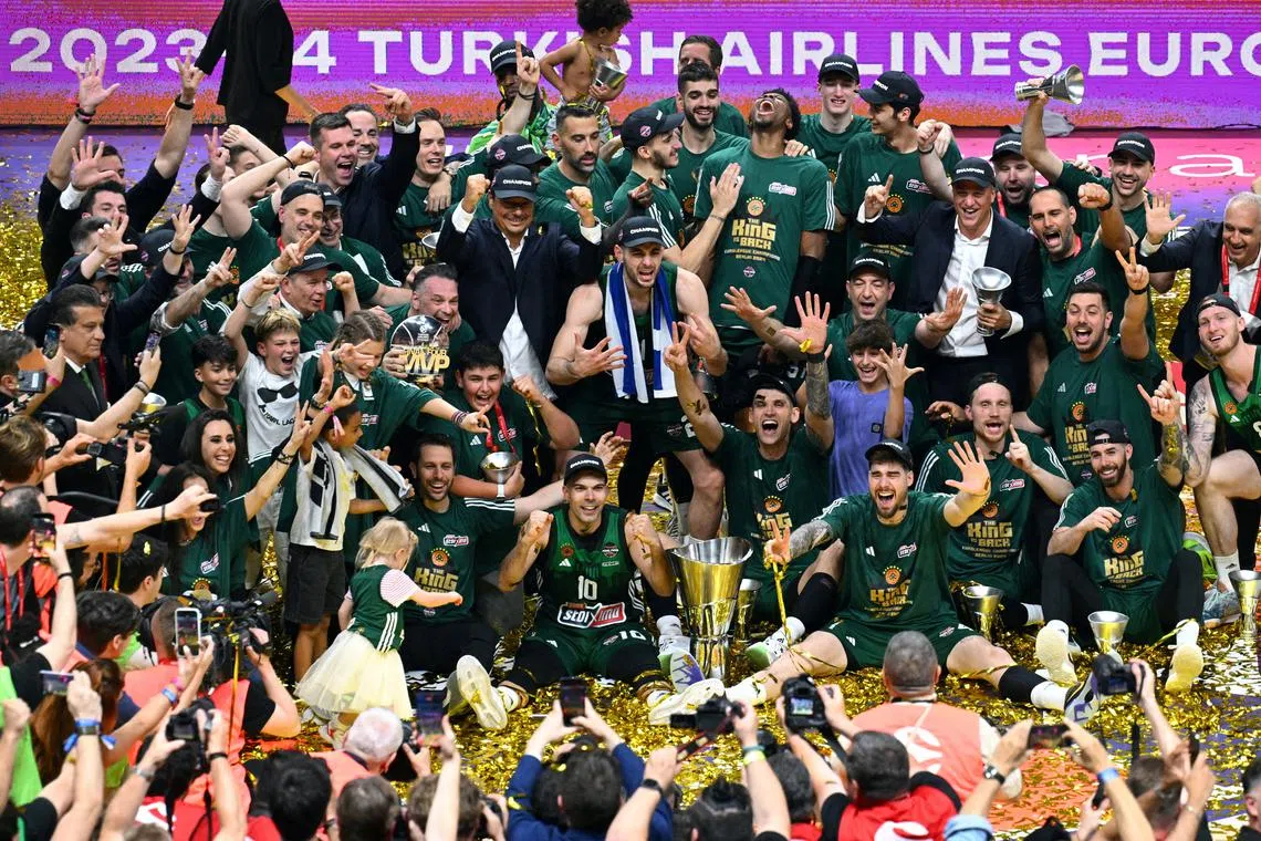 FILE PHOTO: Basketball - EuroLeague - Final - Real Madrid v Panathinaikos BC - Uber Arena, Berlin, Germany - May 26, 2024 Panathinaikos BC players celebrate with the trophy after winning the EuroLeague REUTERS/Annegret Hilse/File Photo