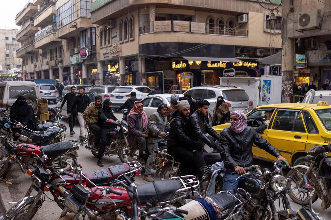 People ride their bikes a long a street in Idlib, a northwestern Syrian city where Hayat Tahrir al-Sham (HTS) had maintained an administration at the time when Syria's civil war front lines were frozen, Syria, December 16, 2024. REUTERS/Umit Bektas