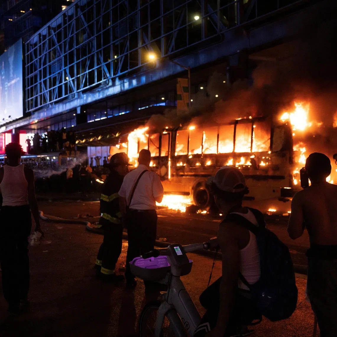 One of the yellow school buses the city government hired to help transport football fans was set on fire, according to a Reuters video journalist who witnessed it in flames.