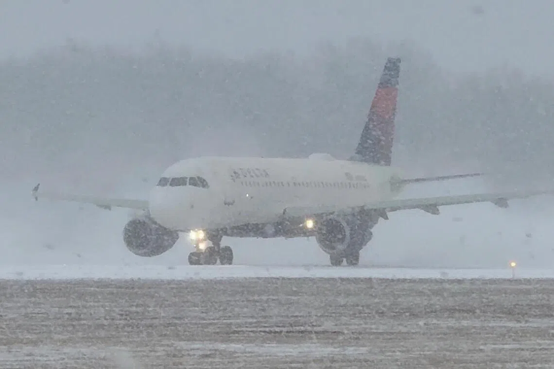 A plane prepares to take off during a winter storm at Greater Rochester International Airport in Rochester, New York.
