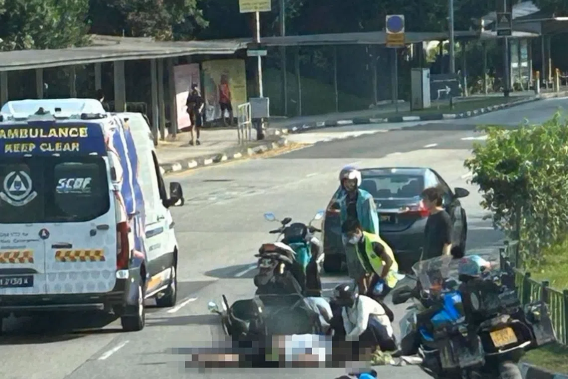 A man could be seen lying face down on the road next to a fallen bike in photos of the accident's aftermath. 