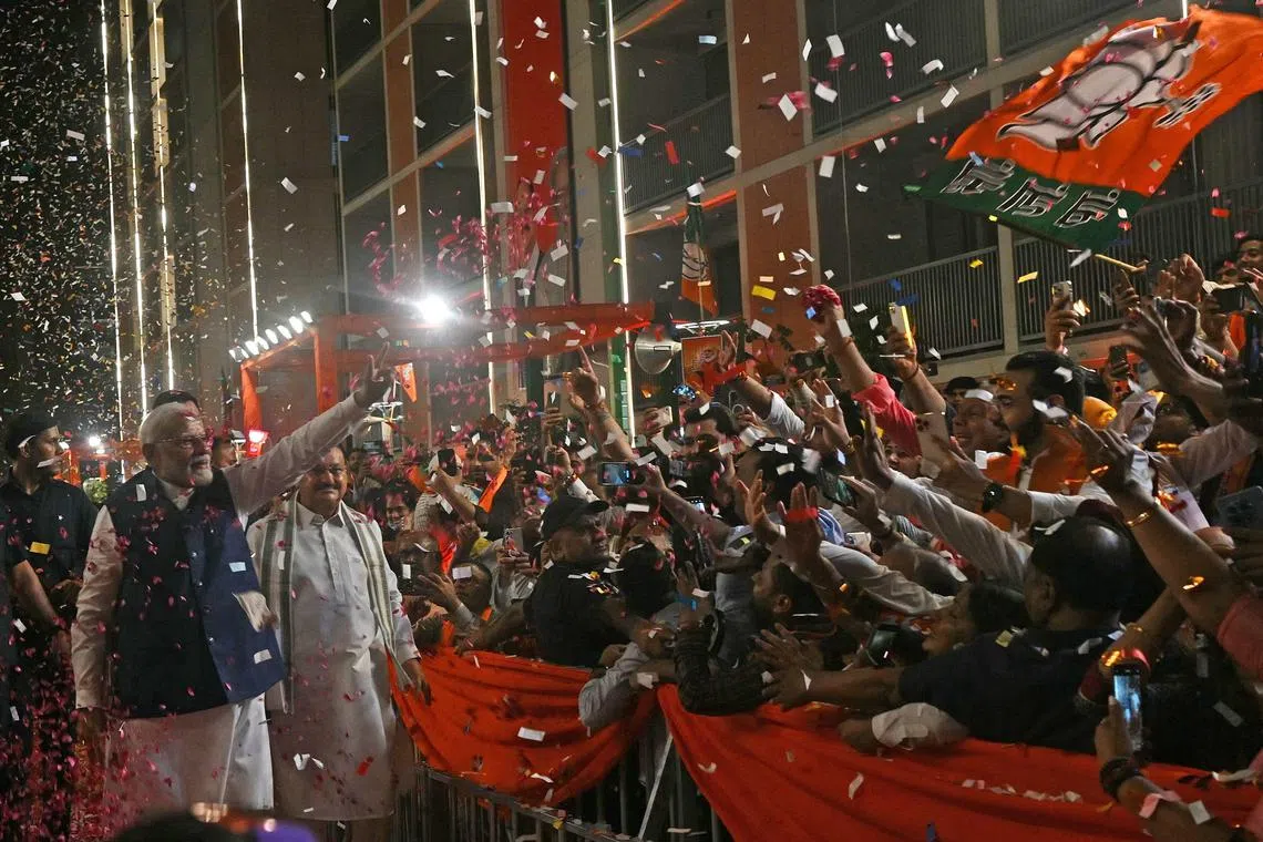 Indian PM Narendra Modi flashing the victory sign as he arrives at the BJP headquarters in New Delhi on June 4, after the country’s general election results were announced.  