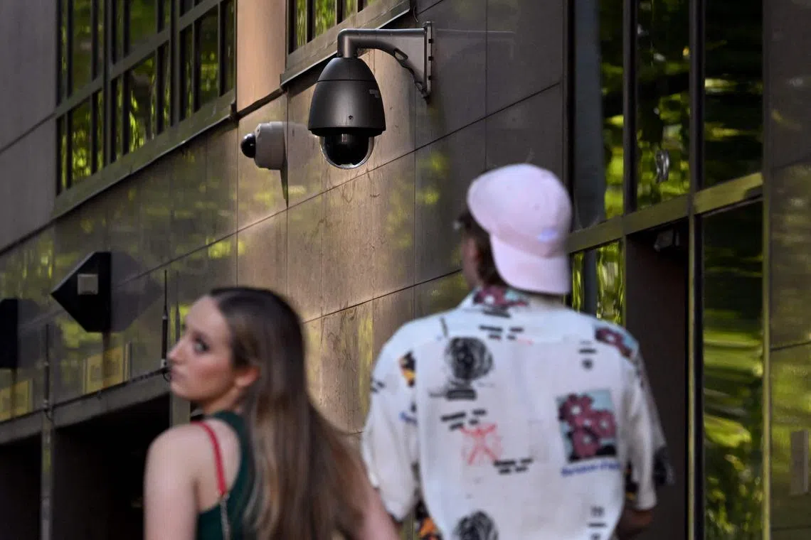 People walk past a security camera in Melbourne. Australia’s defence and foreign ministries are removing surveillance cameras made by Chinese-run firms from their facilities.
