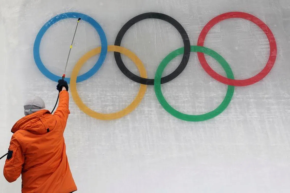 FILE PHOTO: An ice maker installs a sub-glacial Olympic logo ahead of the Beijing 2022 Winter Olympics at Yanqing National Sliding Centre in Yanqing, China, January 28, 2022. REUTERS/Edgar Su/File photo