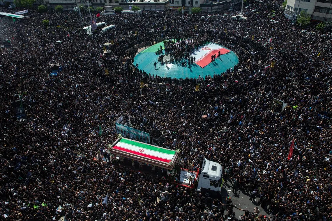 HEADLINE: Funeral in Tehran
CAPTION: A truck carrying the coffins of President Ebrahim Raisi, Foreign Minister Hossein Amir Abdollahian and others is driven through a throng of mourners during a funeral procession in Tehran on Wednesday, May 22, 2024. Raisi, 63, was killed in a helicopter crash along with Abdollahian, 60, and five others traveling with them on Sunday. 
CREDIT: (Arash Khamooshi/The New York Times)