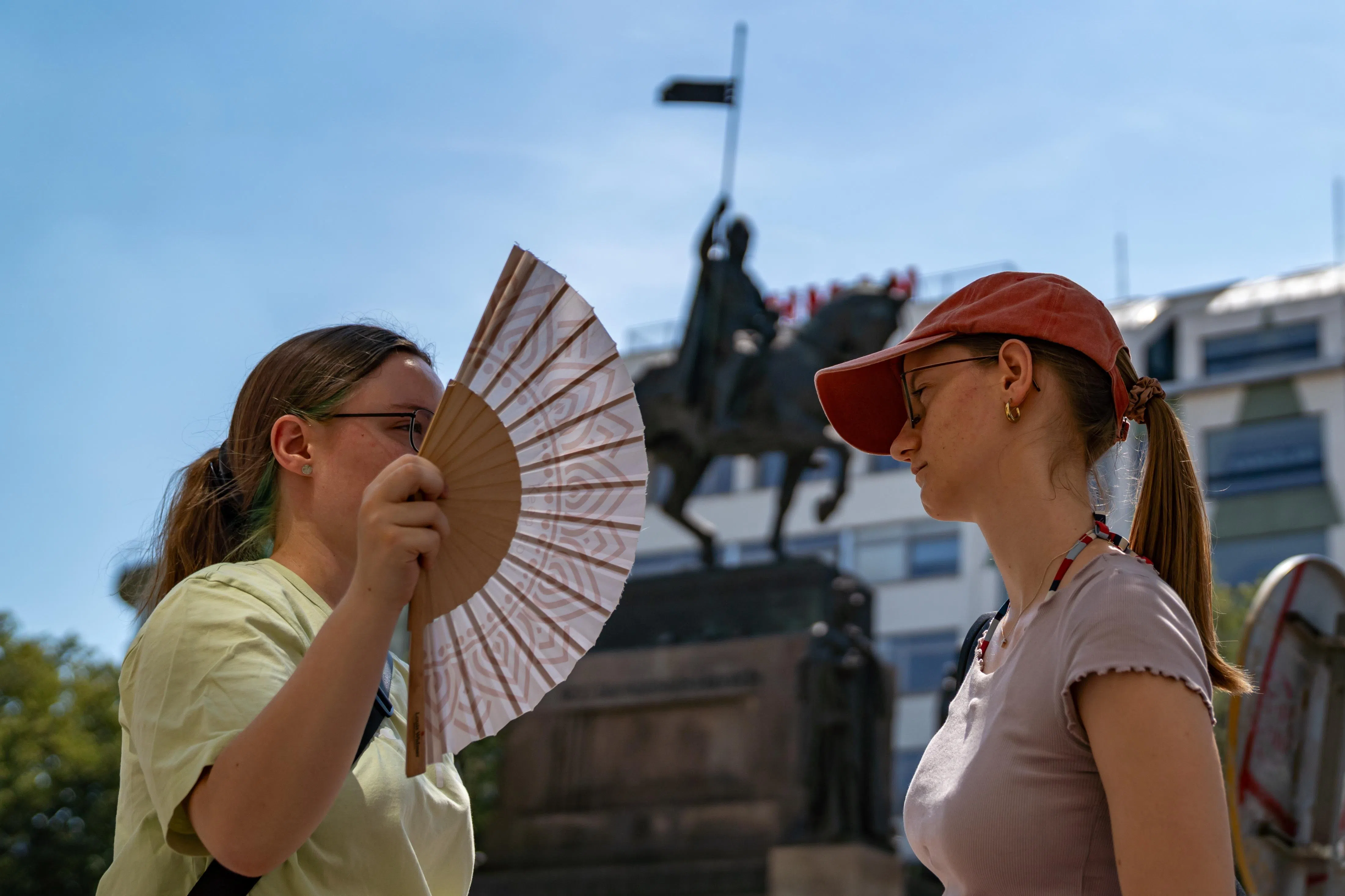 epa13069057 A woman uses a hand fan to keep cool during a hot, sunny day at Wenceslas Square in Prague, Czech Republic, 27 June 2026. According to meteorologists, temperatures in the Czech Republic reached 40 degrees Celsius for the first time since 2012, as readings continued to rise. A record set 20 August 2012 was also broken at one location in the northern part of the country, where 40.6 degrees Celsius was measured.  EPA/FADI YOUSEF