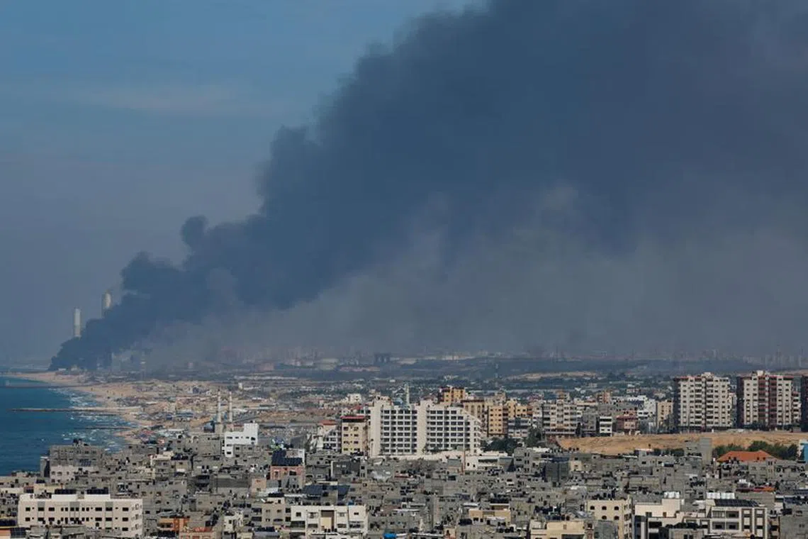 Smoke rises from the Israeli side after Palestinian Hamas gunmen infiltrated areas of southern Israel, as seen from Gaza, October 7, 2023. REUTERS/Mohammed Salem/File Photo