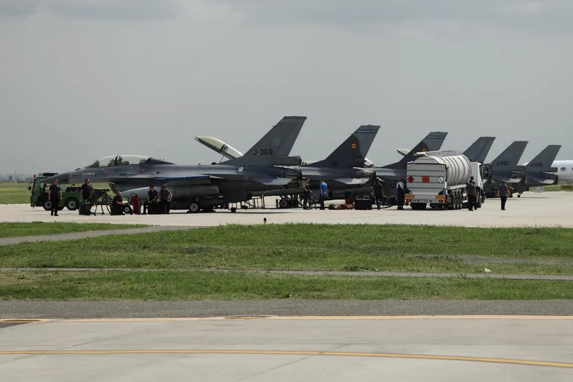Three F-16 fighter jets from Netherlands delivered for Ukraine are seen on the tarmac among Romanian F-16 fighter jets at the European F-16 training center inside the 86th Romanian airbase in Fetesti, Romania, April 17, 2024. REUTERS/Bart Biesemans/ File Photo