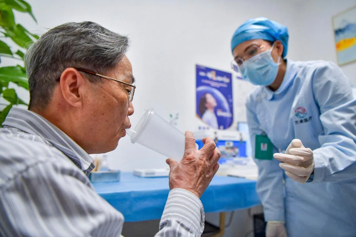 A man receives a dose of inhalable Covid-19 vaccine in Haikou in China's southern Hainan province on Nov 25, 2022. 