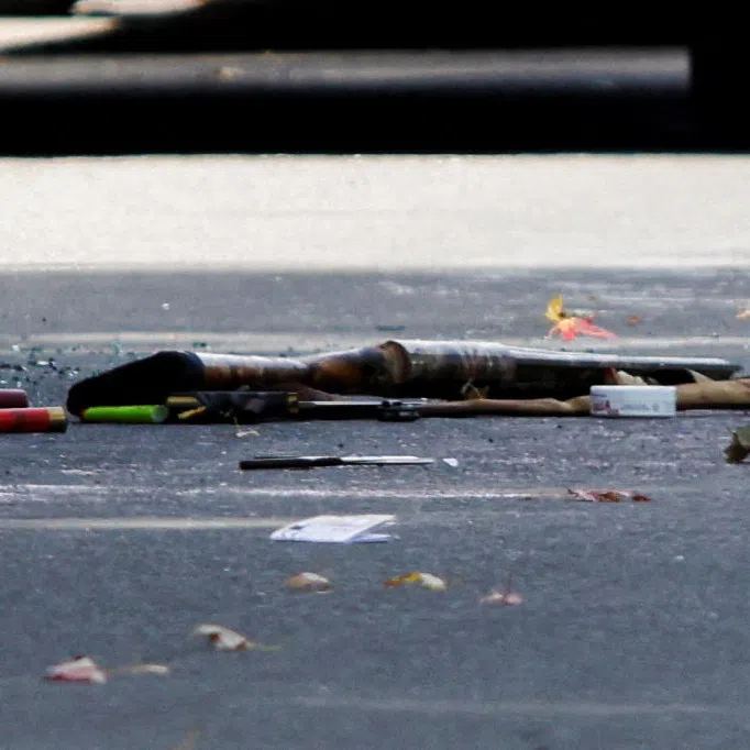 A shotgun and shotgun shells lie on the ground at the scene of a shooting where a police officer was shot outside a Yom Kippur gathering on Sept 21 at Sons of Jacob Synagogue in Belleville, Ontario, Canada.