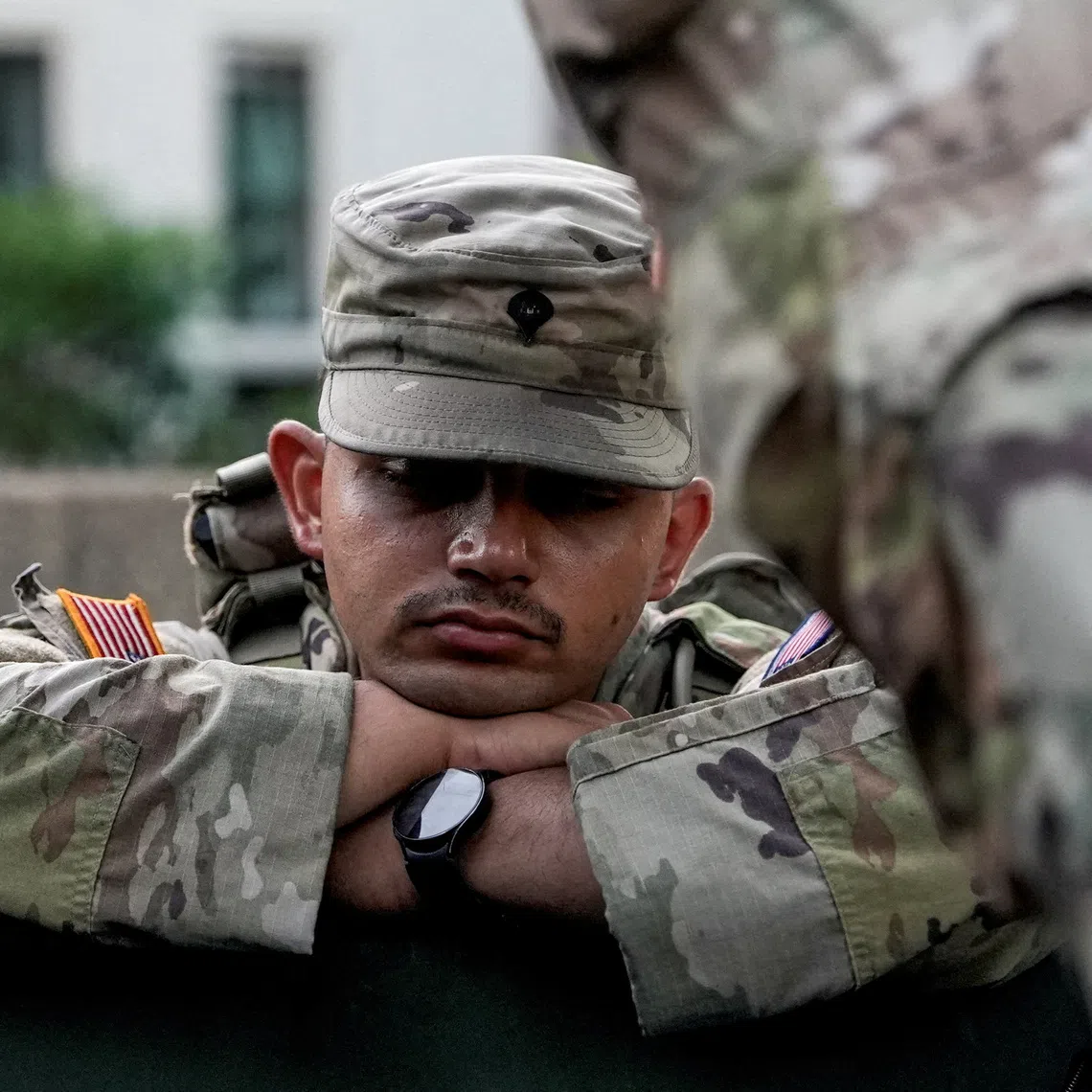 A member of the National Guard rests, after sunrise, as day breaks ahead of Fourth of July celebrations marking the 250th anniversary of U.S. Independence, in Washington, D.C., U.S., July 4, 2026. REUTERS/Cheney Orr