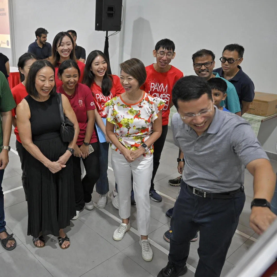 Minister for National Development Desmond Lee (pointing) and Ms Foo Mee Har (in white) viewing plans for Teban and Pandan Gardens alongside residents such as Mr Reginal Satha (in green) and Ms Elsie Nee (in black).